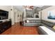 A living room featuring wood floors, a ceiling fan, and a view to the kitchen at 9206 Brindlewood Dr, Odessa, FL 33556