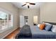 This main bedroom features an exterior door, wood floors, and a walk-in closet at 9206 Brindlewood Dr, Odessa, FL 33556