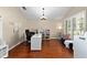Bright home office with hardwood floors, shutters, and a cozy sitting area at 9206 Brindlewood Dr, Odessa, FL 33556