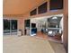 A large patio looks into a living room with a modern sectional sofa at 9206 Brindlewood Dr, Odessa, FL 33556