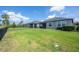 Home's backyard has ample green space, metal fence, and pond views at 9672 Ivory Dr, Ruskin, FL 33573