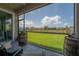 Screened lanai offers picturesque views of a lush lawn and backyard, creating a serene outdoor space at 9672 Ivory Dr, Ruskin, FL 33573