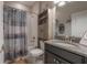 Bathroom featuring granite countertop vanity, neutral tile flooring, and tub with a shower at 9672 Ivory Dr, Ruskin, FL 33573