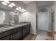 A spacious bathroom featuring a double sink vanity with granite countertops and ample lighting and tile flooring at 9672 Ivory Dr, Ruskin, FL 33573