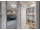 View from doorway into a bedroom, showing a bed and furniture on carpet and shower with curtain to the right at 9672 Ivory Dr, Ruskin, FL 33573