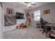 Neutral bedroom showcases carpet, a ceiling fan, a desk, and a Michael Jordan poster, decorated in a teenage style at 9672 Ivory Dr, Ruskin, FL 33573