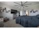 Spacious bedroom with a large bed, ceiling fan, and custom shelving for decor at 9672 Ivory Dr, Ruskin, FL 33573