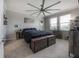 Cozy bedroom featuring a large ceiling fan, natural light, and neutral decor at 9672 Ivory Dr, Ruskin, FL 33573