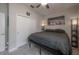 A cozy bedroom featuring carpet flooring, a ceiling fan, and artwork at 9672 Ivory Dr, Ruskin, FL 33573