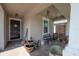 Charming covered front porch adorned with rustic decor, including a decorative fountain and a 'Welcome' bench at 9672 Ivory Dr, Ruskin, FL 33573