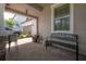 Cozy front porch featuring a bench and barrel decor, sheltered by a covered entrance with brick flooring at 9672 Ivory Dr, Ruskin, FL 33573