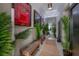 Eclectic hallway adorned with sports memorabilia, lush potted plants, and unique neon sign lighting at 9672 Ivory Dr, Ruskin, FL 33573