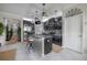 Charming kitchen with dark cabinetry, granite countertops, pendant lights and island with stools at 9672 Ivory Dr, Ruskin, FL 33573