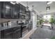 Granite counters and stainless steel appliances accent the dark cabinets in this modern kitchen at 9672 Ivory Dr, Ruskin, FL 33573