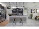 Kitchen island featuring dark cabinets, pendant lighting, breakfast bar, and stainless appliances at 9672 Ivory Dr, Ruskin, FL 33573