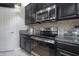 Modern kitchen with stainless steel appliances, granite countertops, and a mosaic tile backsplash at 9672 Ivory Dr, Ruskin, FL 33573