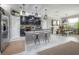 Open kitchen and dining area with stainless steel appliances, island seating, and natural light at 9672 Ivory Dr, Ruskin, FL 33573