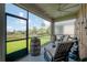 Screened-in lanai with comfortable seating provides a tranquil outdoor living space with picturesque backyard views at 9672 Ivory Dr, Ruskin, FL 33573