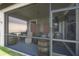 A cozy screened patio features barrel accents and a ceiling fan at 9672 Ivory Dr, Ruskin, FL 33573