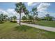 A scenic pond view with a walking path surrounded by trees and grassy areas at 9672 Ivory Dr, Ruskin, FL 33573