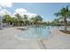 A community pool with palm trees, sun loungers, and a zero entry wading pool with fountains at 9672 Ivory Dr, Ruskin, FL 33573