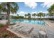 A relaxing community pool area with lounge chairs and a covered pavilion for residents at 9672 Ivory Dr, Ruskin, FL 33573