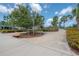 A scenic walking path through the community, featuring lush landscaping and inviting benches at 9672 Ivory Dr, Ruskin, FL 33573