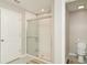 Bathroom features a shower with glass doors and tile flooring, and a toilet at 9814 Quadrangle Ct, Sun City Center, FL 33573