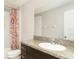 Bathroom featuring a vanity with granite countertop, a large mirror, and a shower with a floral curtain at 9814 Quadrangle Ct, Sun City Center, FL 33573