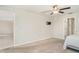 Neutral bedroom features carpet flooring, a ceiling fan, and wall mount for TV at 9814 Quadrangle Ct, Sun City Center, FL 33573