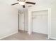 Neutral bedroom features carpet flooring, an open closet, and a ceiling fan at 9814 Quadrangle Ct, Sun City Center, FL 33573