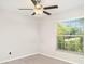 Neutral bedroom features carpet flooring, a window with blinds, and a ceiling fan at 9814 Quadrangle Ct, Sun City Center, FL 33573