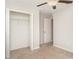 Neutral bedroom features carpet flooring, an open closet, and a ceiling fan at 9814 Quadrangle Ct, Sun City Center, FL 33573