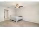 Neutral bedroom with ceiling fan and gray carpet flooring throughout the room at 9814 Quadrangle Ct, Sun City Center, FL 33573
