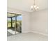 Bright dining room with sliding glass doors that lead to the screened lanai and backyard at 9814 Quadrangle Ct, Sun City Center, FL 33573