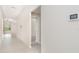 Bright hallway showcases the home's tile flooring and seamless flow into the living areas at 9814 Quadrangle Ct, Sun City Center, FL 33573