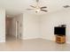 Spacious living room with tile flooring, ceiling fan, and a clean, neutral color palette at 9814 Quadrangle Ct, Sun City Center, FL 33573