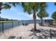 Brick-paved lakeside patio featuring chairs and a fire pit, perfect for enjoying tranquil outdoor moments and scenic views at 9814 Quadrangle Ct, Sun City Center, FL 33573