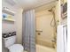 Bathroom featuring tiled shower and bathtub combination with decor on shelves and a toilet at 3078 Eastland Blvd # 205, Clearwater, FL 33761