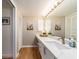 Bathroom featuring an expansive vanity with double sinks, soft lighting and neutral colors at 3078 Eastland Blvd # 205, Clearwater, FL 33761