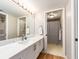 Bathroom featuring an extended vanity with white cabinets and a view of the shower at 3078 Eastland Blvd # 205, Clearwater, FL 33761