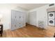 Bright bedroom featuring wood laminate floors, a built in wardrobe and a laundry room at 3078 Eastland Blvd # 205, Clearwater, FL 33761