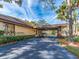Long driveway with a porte cochere, well-maintained landscaping, and a serene atmosphere at 3078 Eastland Blvd # 205, Clearwater, FL 33761