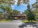 Well-manicured grounds featuring a circular driveway, porte cochere, and mature trees at 3078 Eastland Blvd # 205, Clearwater, FL 33761