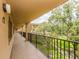This exterior hallway offers a view of lush landscaping and serene walkways at 3078 Eastland Blvd # 205, Clearwater, FL 33761