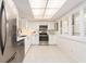 The updated kitchen features stainless steel appliances, white cabinets, and modern finishes at 3078 Eastland Blvd # 205, Clearwater, FL 33761
