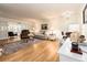 Spacious living room boasts hardwood floors, ample seating, and natural light at 3078 Eastland Blvd # 205, Clearwater, FL 33761