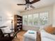 Bright living room featuring a bookshelf, plush seating and plantation shutters allowing natural light at 3078 Eastland Blvd # 205, Clearwater, FL 33761