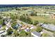 An aerial view highlighting neighborhood street and mature trees, golf course, tennis courts, and landscaping at 1005 45Th W St, Bradenton, FL 34209