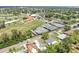 An aerial shot showcasing the neighborhood, community golf course, and tennis courts on a sunny day at 1005 45Th W St, Bradenton, FL 34209